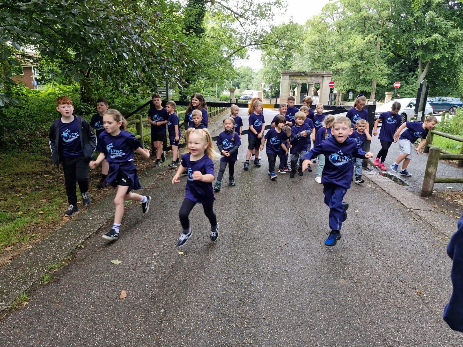 Children running along the park path together