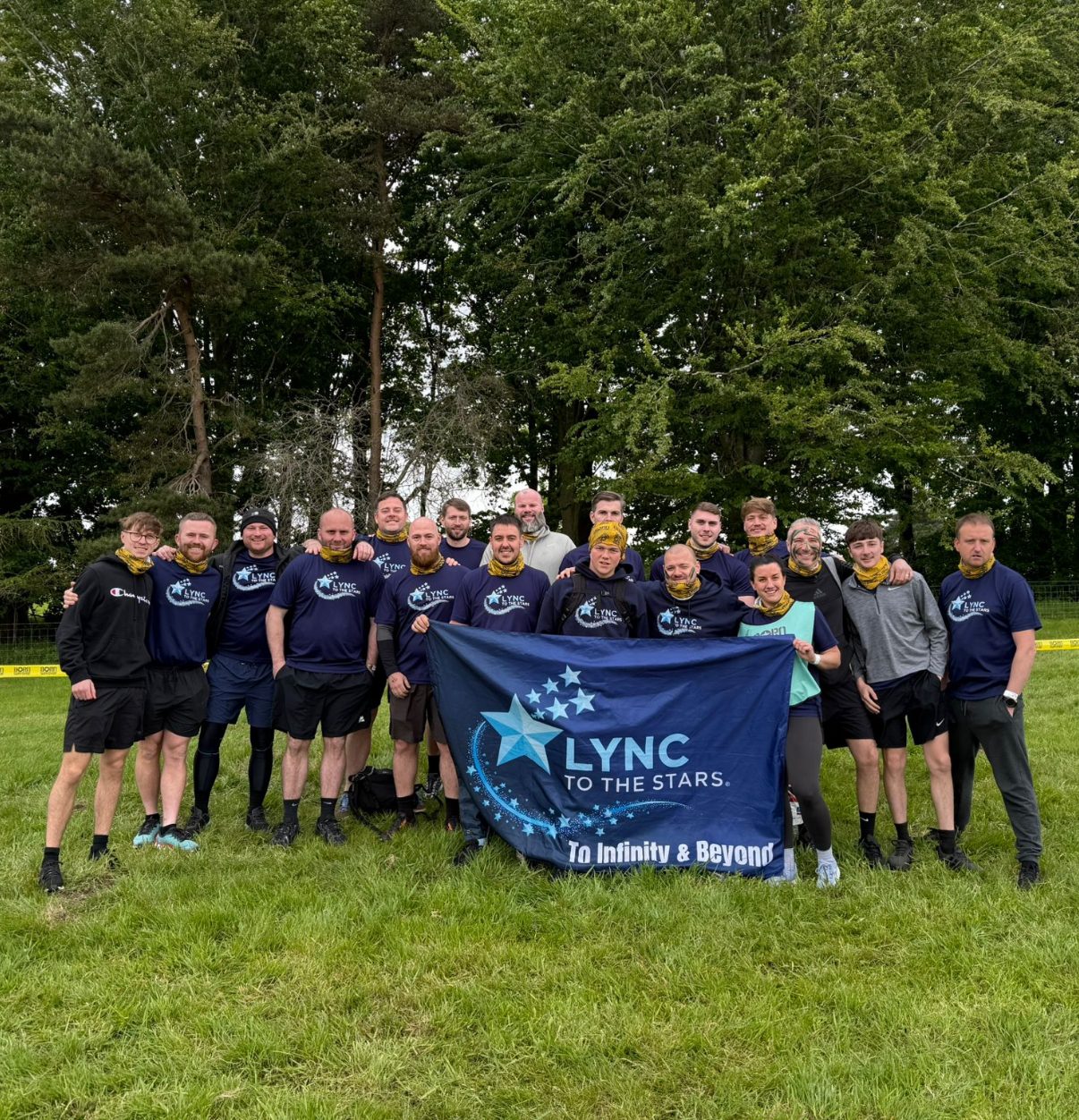 The Born Survivor team holding the Lync to the Stars banner before the start