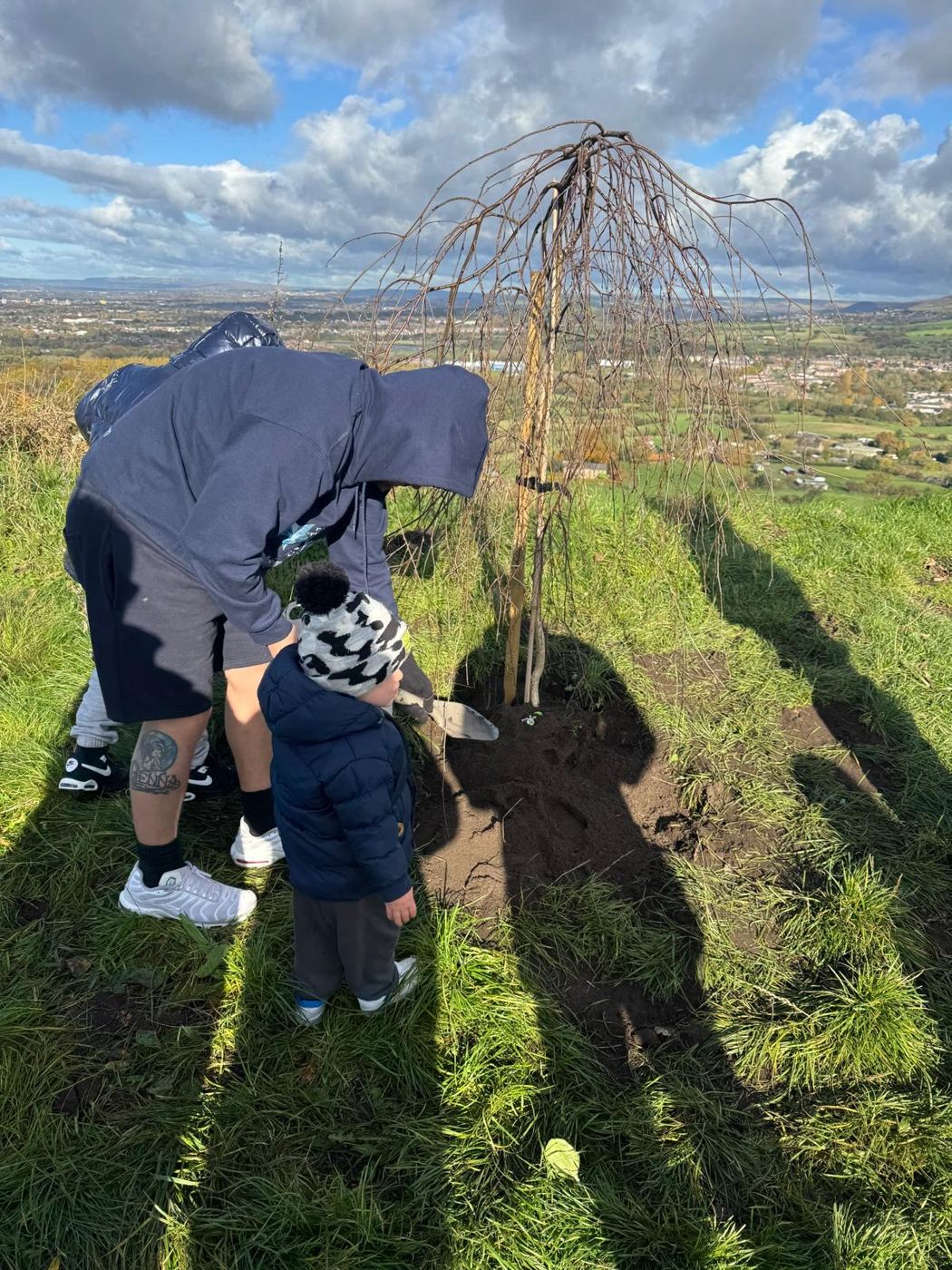 Planting Lync's Tree together, with a little helper