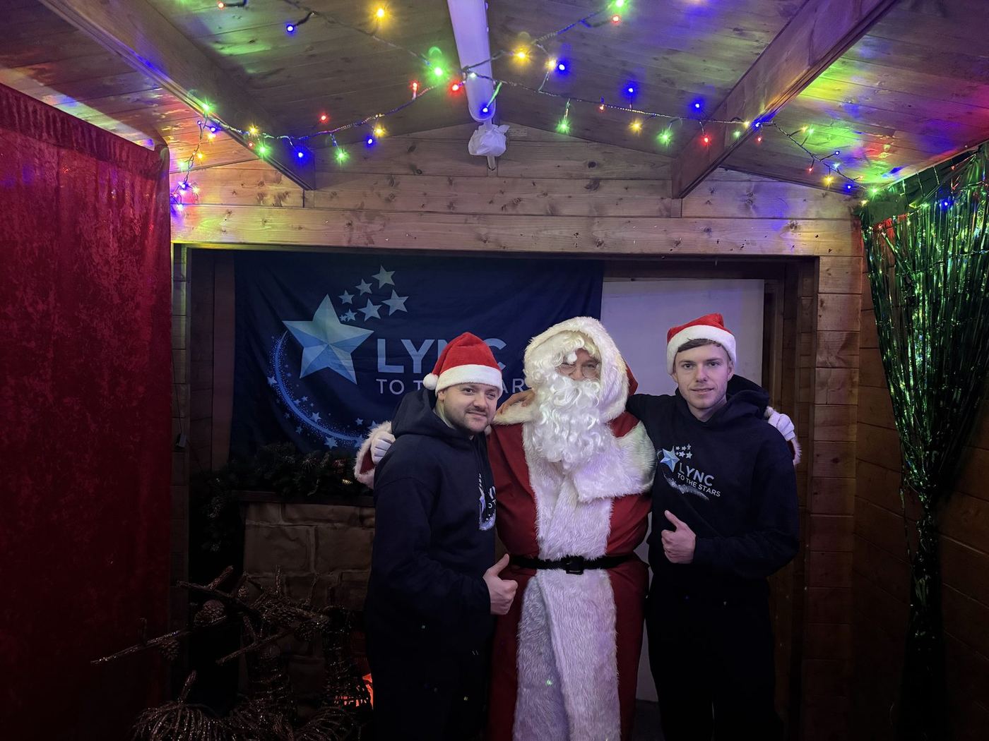 Two of the team with Santa in the grotto