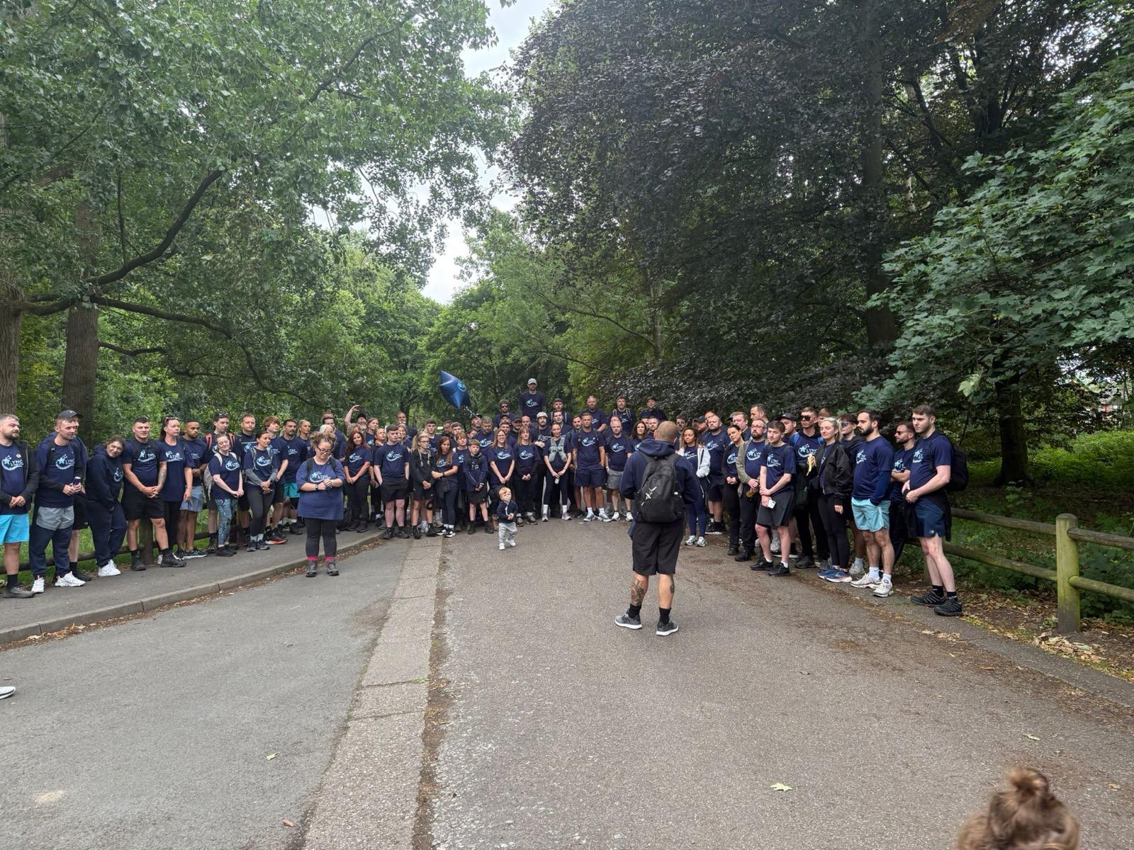 A big group of walkers together on the wooded road out of Stockport