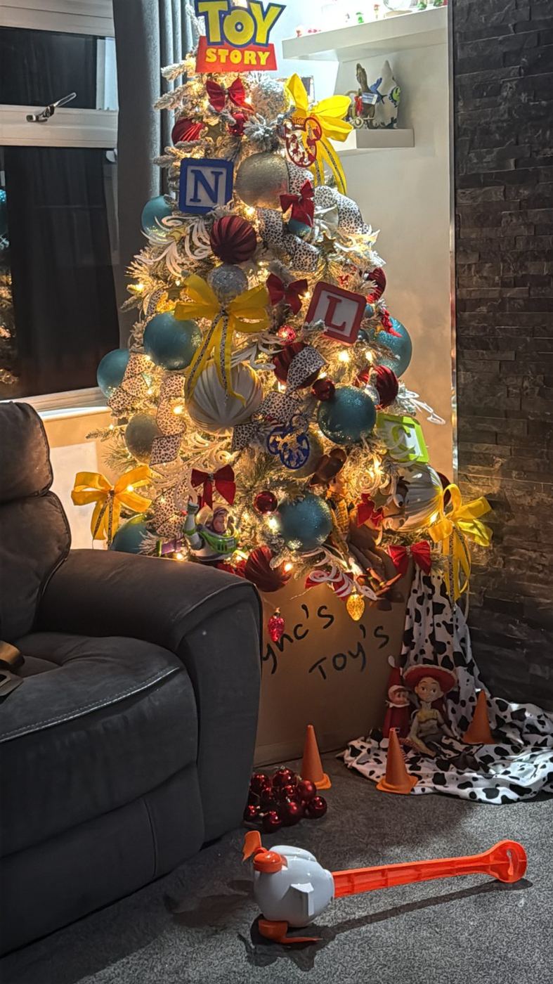 Natalie's Toy Story Christmas tree glowing in the living room