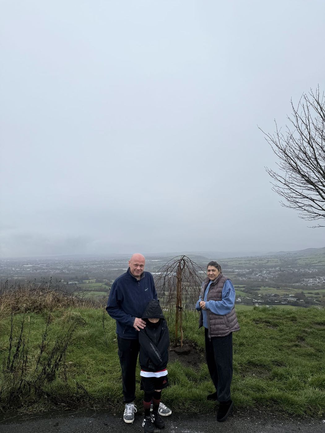 Two visitors at Lync's Tree on a misty day