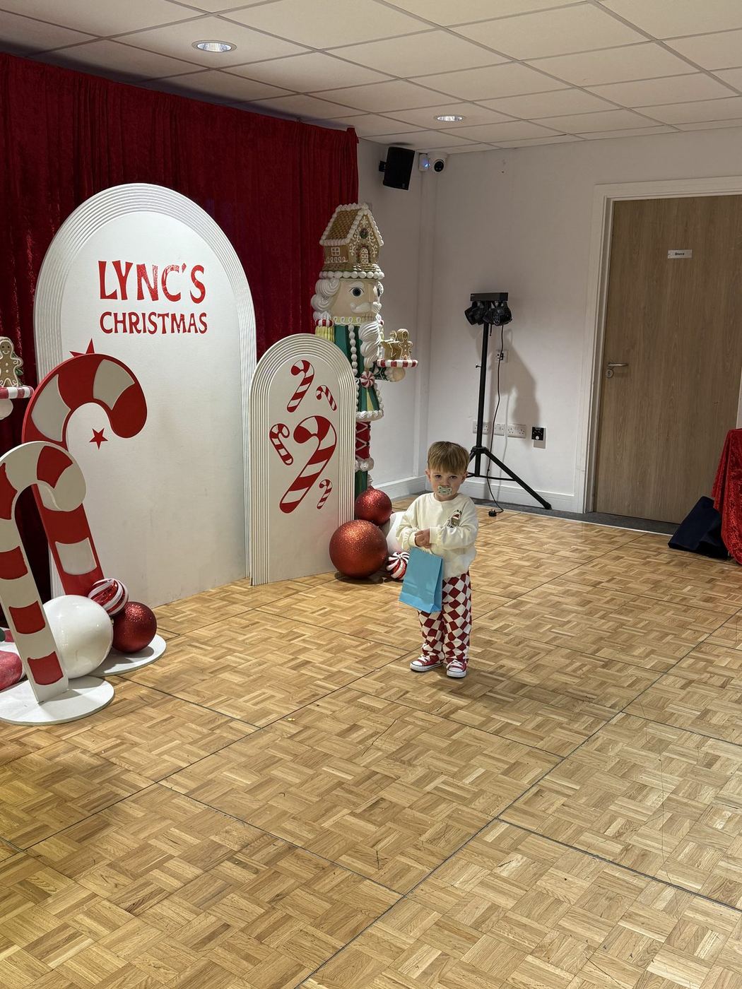 A little one exploring the Lync's Christmas backdrop