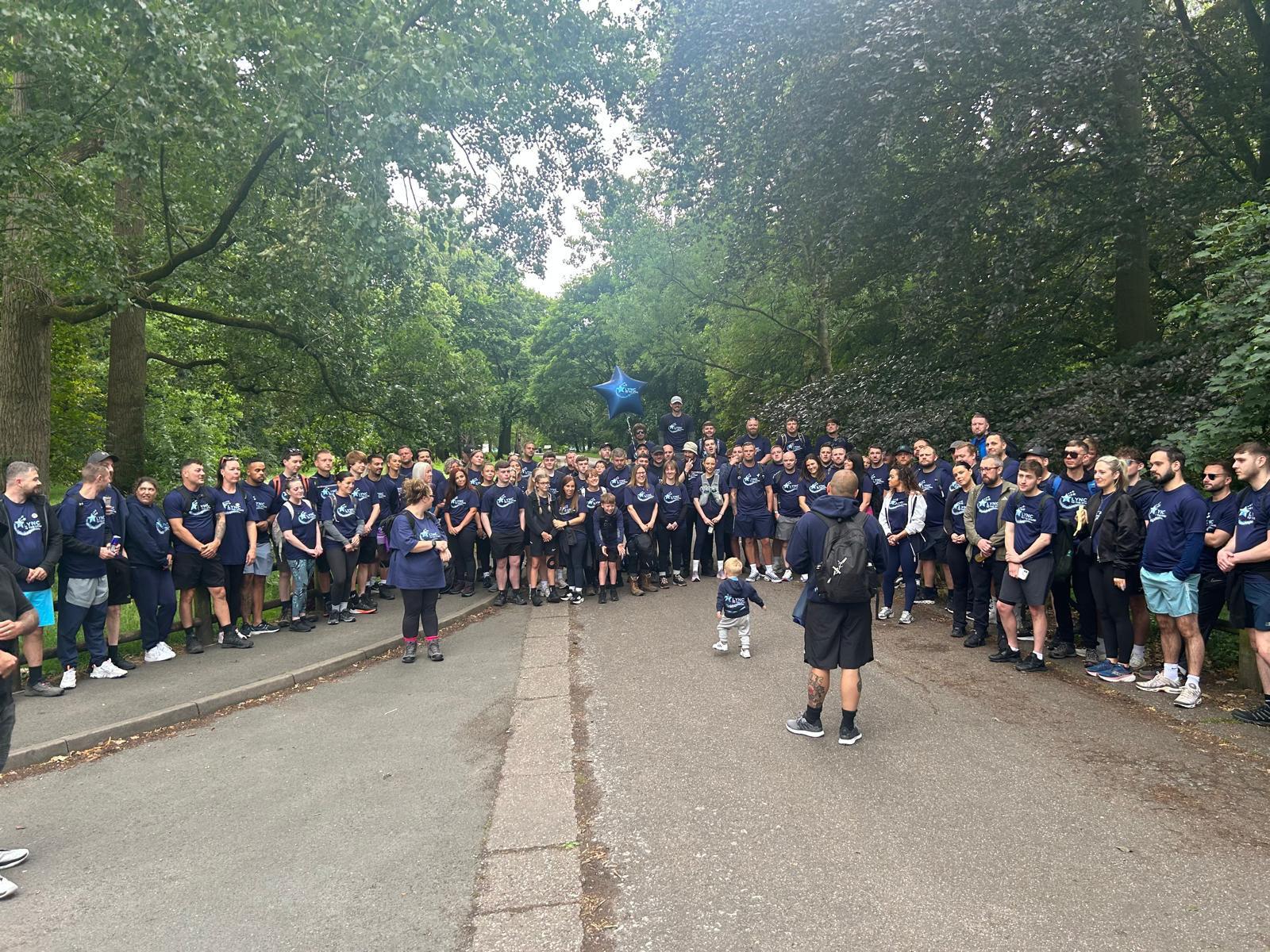Walkers gathered along the route, all walking for Lync