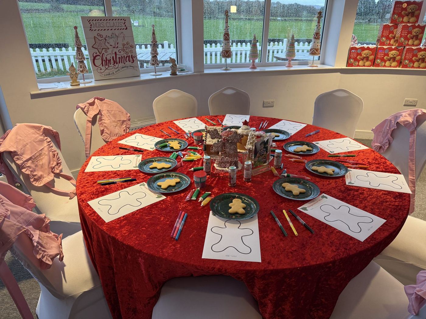 A table set with red velvet and Christmas crafts